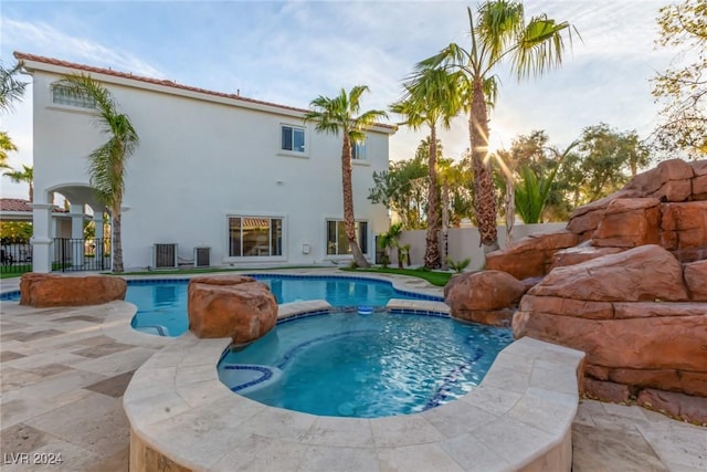 view of swimming pool with a patio, an in ground hot tub, and central AC unit