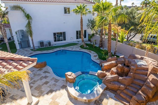 view of swimming pool with a patio area and an in ground hot tub