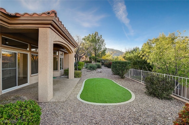 view of yard with a mountain view and a patio