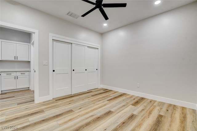 unfurnished bedroom with ceiling fan and light hardwood / wood-style floors