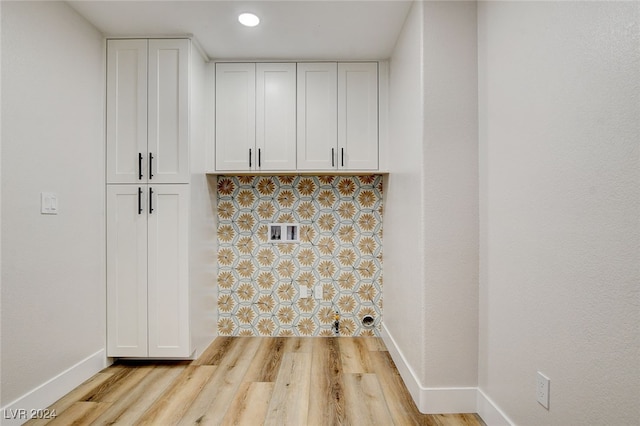 laundry room with light hardwood / wood-style floors