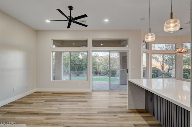 kitchen featuring pendant lighting, light hardwood / wood-style floors, plenty of natural light, and ceiling fan