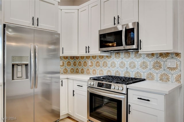 kitchen with decorative backsplash, light stone counters, white cabinets, and stainless steel appliances