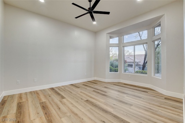 empty room featuring ceiling fan and light wood-type flooring