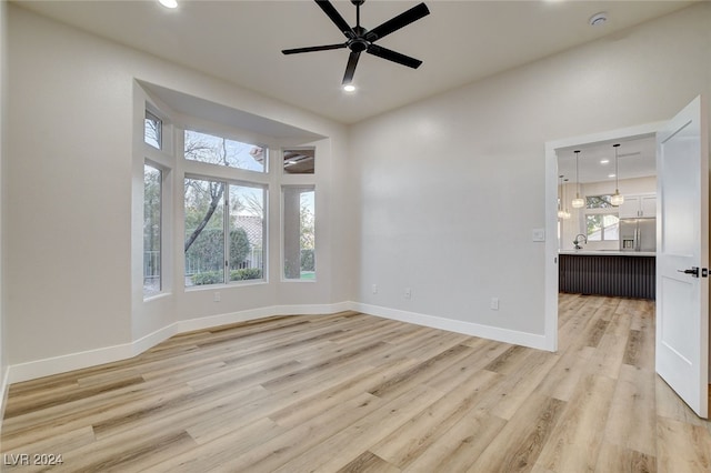 empty room featuring ceiling fan and light hardwood / wood-style floors