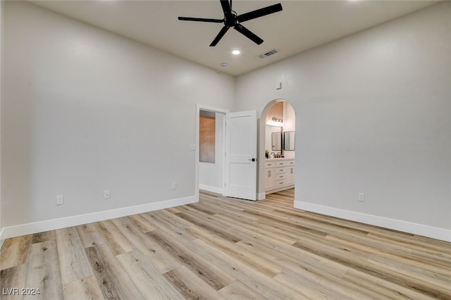 unfurnished room featuring ceiling fan, light hardwood / wood-style floors, and a high ceiling