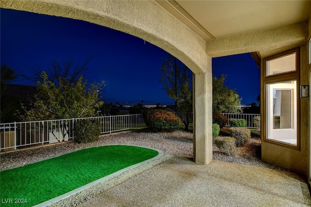 yard at twilight featuring a patio area