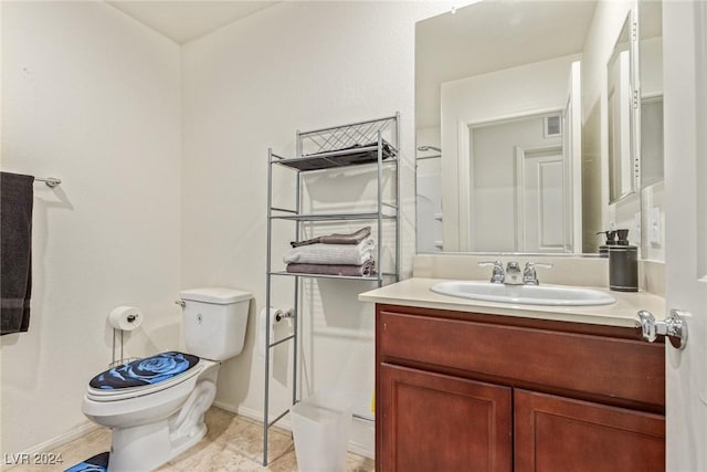 half bathroom featuring vanity, toilet, baseboards, and visible vents