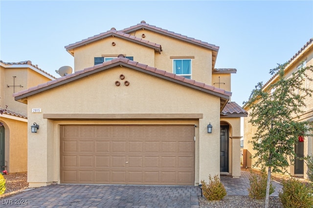 mediterranean / spanish-style house featuring a garage