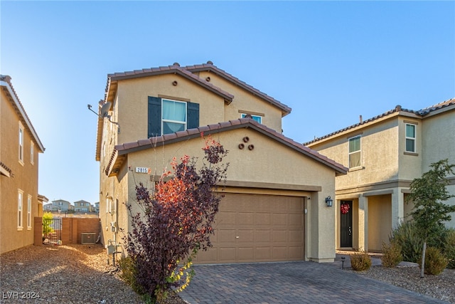 mediterranean / spanish-style house with a garage and cooling unit