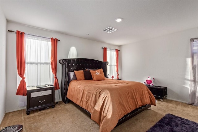 bedroom featuring light colored carpet, baseboards, and visible vents