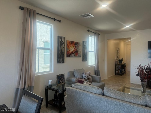 living room with light tile patterned flooring, visible vents, a wealth of natural light, and recessed lighting