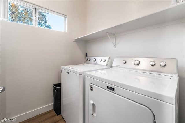 laundry room with dark hardwood / wood-style flooring and independent washer and dryer