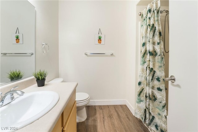 bathroom with a shower with curtain, vanity, toilet, and wood-type flooring