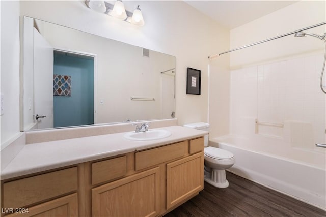 full bathroom featuring vanity, toilet, wood-type flooring, and bathtub / shower combination