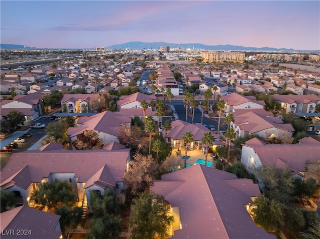 aerial view at dusk featuring a mountain view