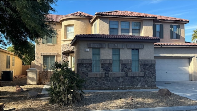 mediterranean / spanish-style home with a garage and central AC