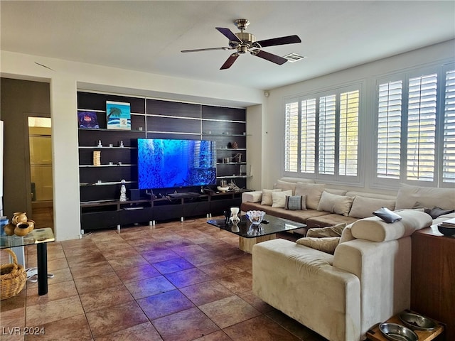 tiled living room featuring ceiling fan and built in features