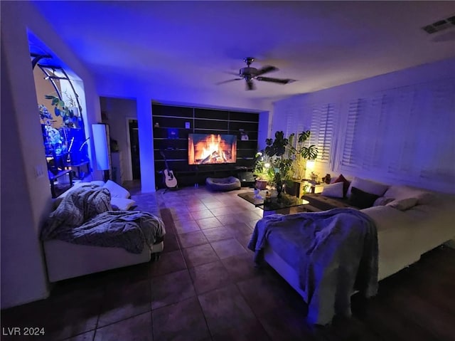 cinema room featuring tile patterned floors and ceiling fan