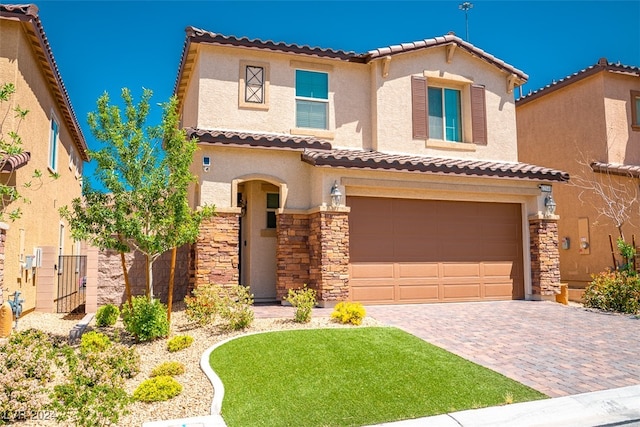 mediterranean / spanish house with a garage