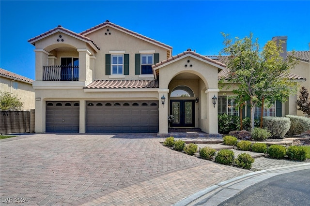 mediterranean / spanish house featuring french doors and a garage