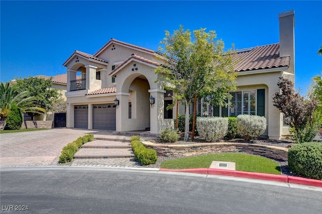 mediterranean / spanish house featuring a garage