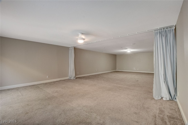 unfurnished room featuring light colored carpet