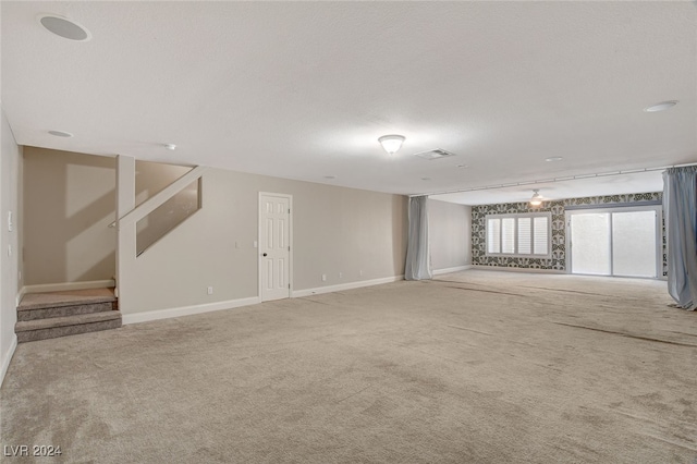 carpeted spare room with a textured ceiling