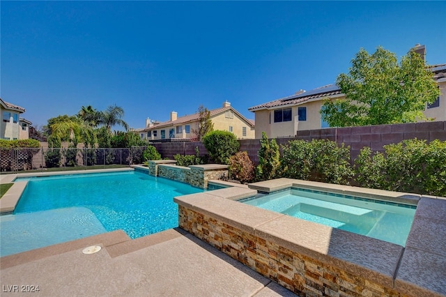 view of swimming pool featuring an in ground hot tub