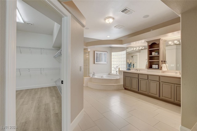 bathroom featuring a bathing tub, vanity, and wood-type flooring