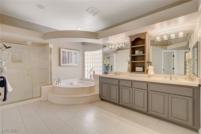 bathroom with tile patterned flooring, vanity, and plus walk in shower