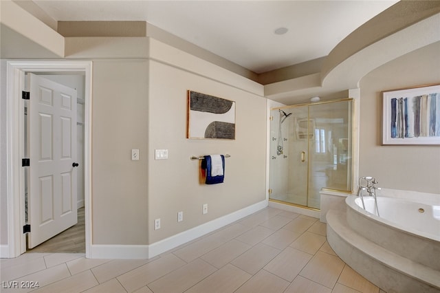 bathroom with tile patterned floors and separate shower and tub