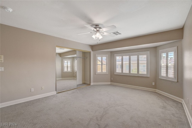 unfurnished room featuring light carpet and ceiling fan