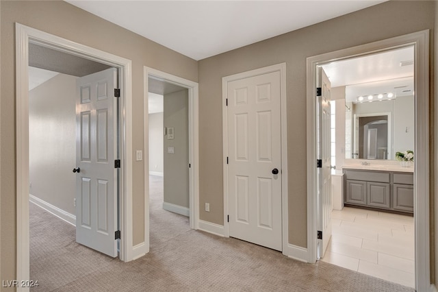 hallway with light colored carpet