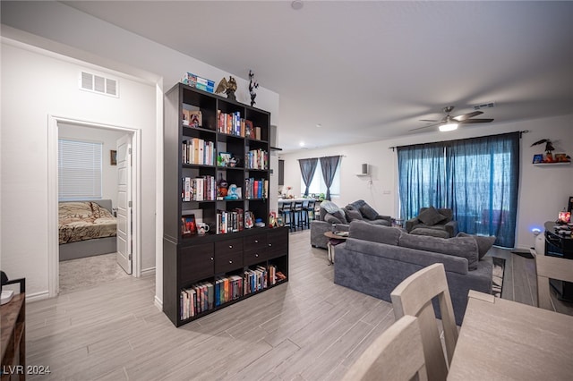 living room featuring ceiling fan and light hardwood / wood-style flooring