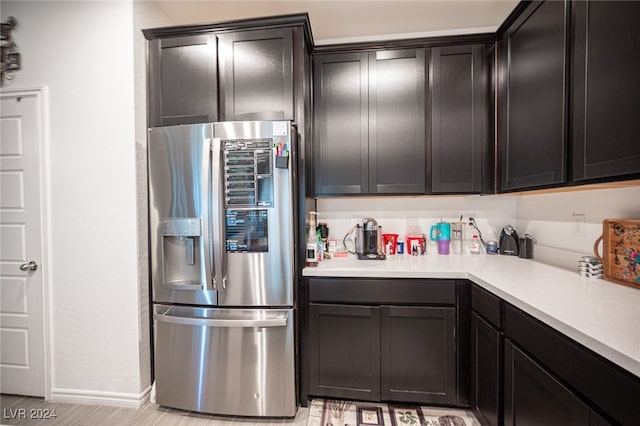 kitchen featuring light wood-type flooring and stainless steel fridge with ice dispenser