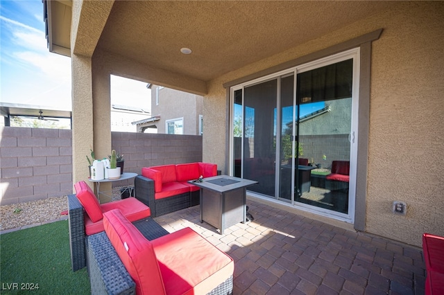 view of patio / terrace featuring an outdoor living space with a fire pit