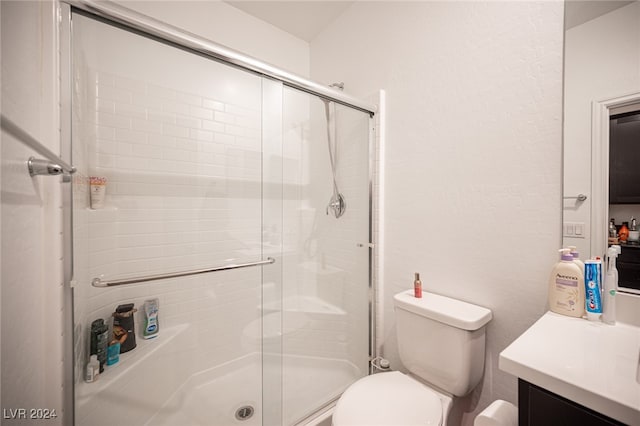 bathroom featuring vanity, toilet, and walk in shower