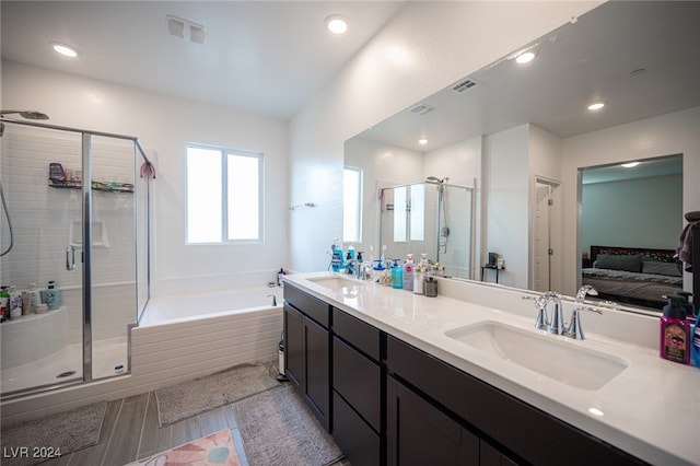 bathroom with vanity and independent shower and bath