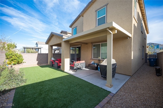 rear view of house featuring a patio and a lawn