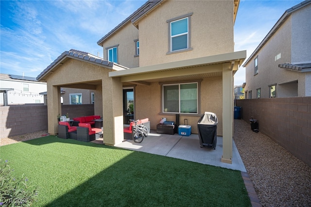 rear view of property featuring a yard, an outdoor living space, and a patio area