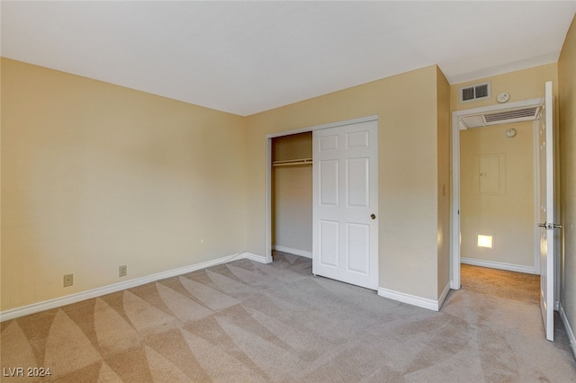 unfurnished bedroom featuring carpet, a closet, visible vents, and baseboards