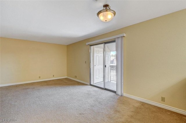 carpeted spare room with baseboards