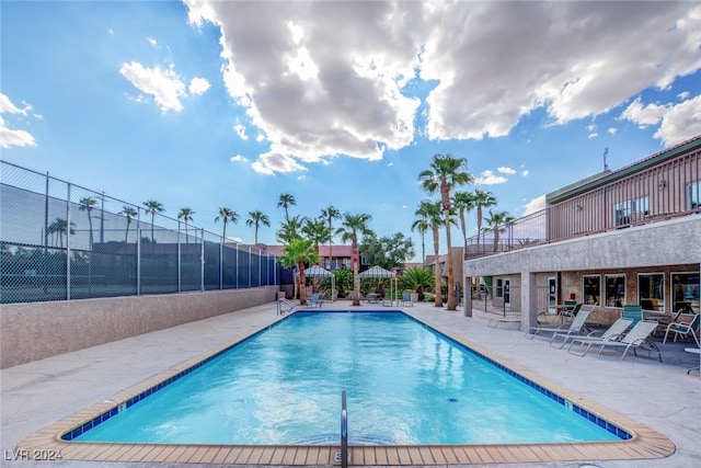 community pool featuring a patio area and fence