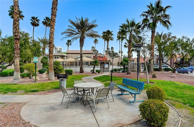 surrounding community featuring a yard, fence, and a patio