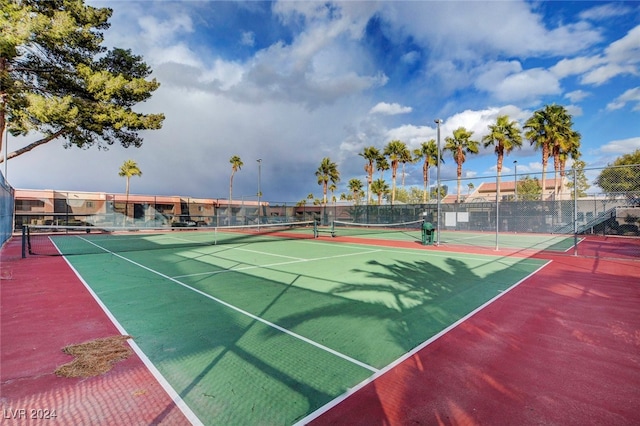 view of sport court featuring fence