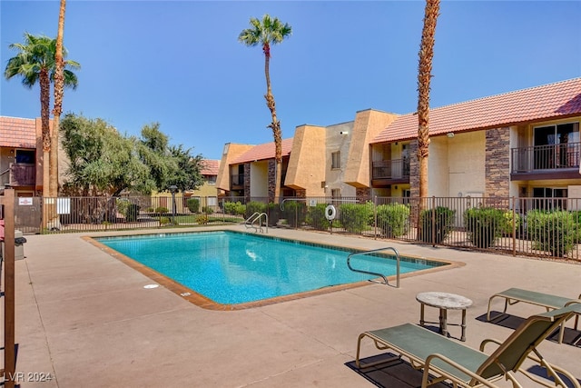 pool featuring a patio area and fence