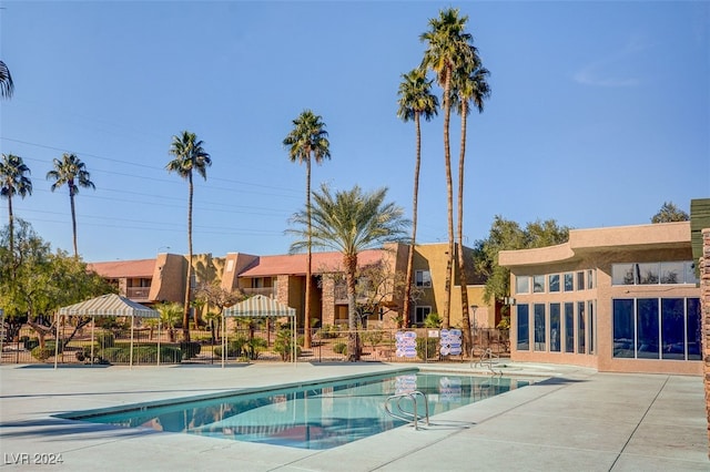 community pool featuring a patio area and fence