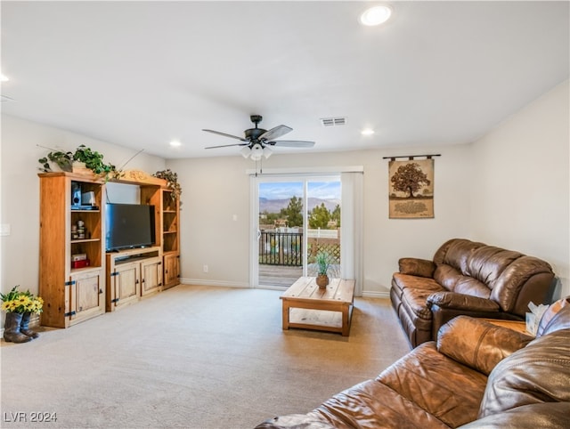 living room featuring ceiling fan and light colored carpet