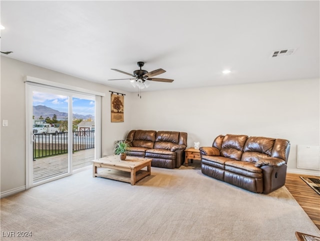 living room with light hardwood / wood-style flooring and ceiling fan